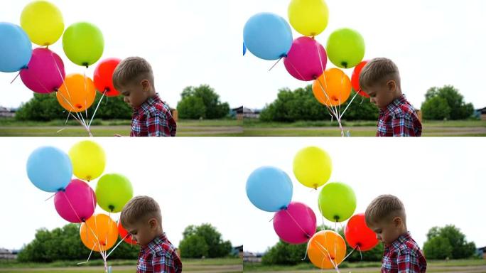 快乐男孩在公园玩气球。散步和户外活动