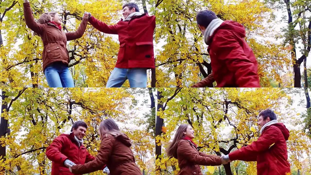 快乐的年轻夫妇在秋季公园玩得开心