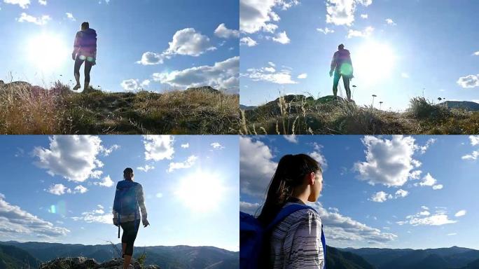 低角度的女人在山顶的日落徒步女孩庆祝生活风景自然景观享受假期旅行冒险