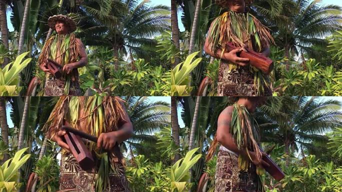 太平洋岛民男子在一个小的木棍鼓上玩耍