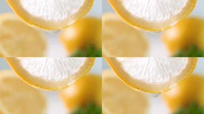 从柠檬片的侧面慢慢滴下来的特写慢动作镜头
