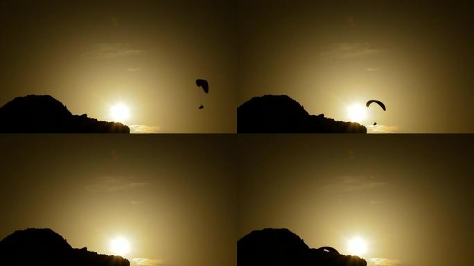 滑翔伞运动员在日落时练习滑翔伞运动