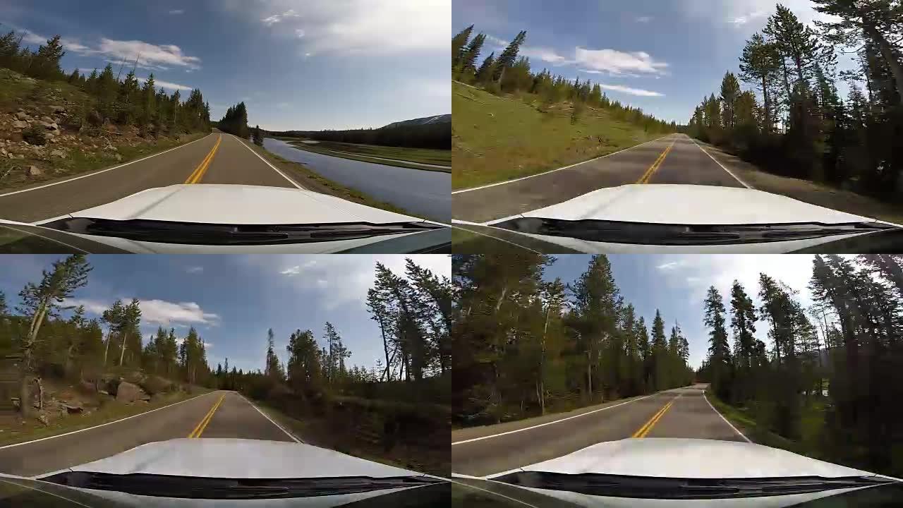 黄石国家公园山脉森林的驾驶视点。从杰克逊霍尔到提顿国家公园和美国怀俄明州黄石国家公园的高速公路