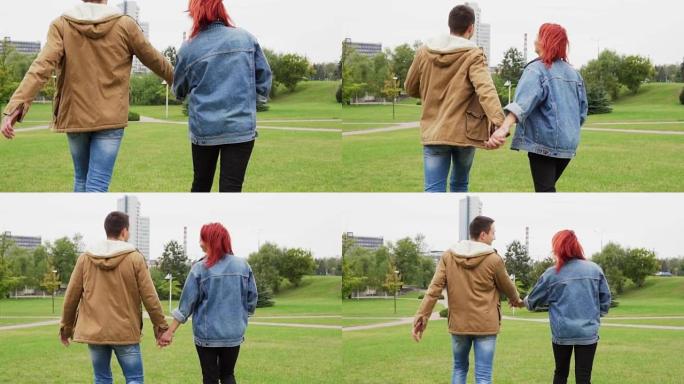 年轻夫妇牵手在城市公园散步