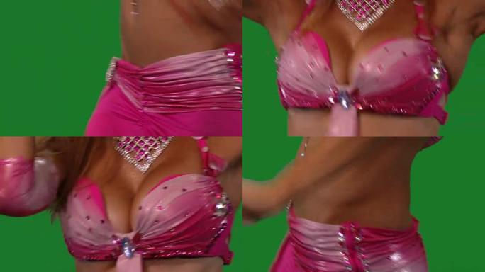 舞者。肚皮舞。肚皮舞者跳舞。绿色的屏幕。性感的粉红色裙子