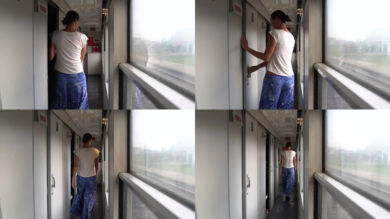 一名妇女离开火车车厢，前往前厅