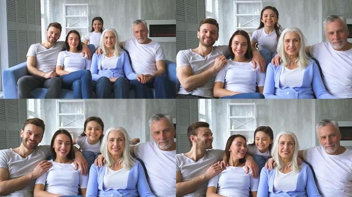 坐在沙发上的幸福家庭。慢动作