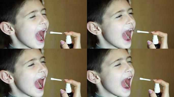 母亲在小男孩的嘴里喷医疗喷雾