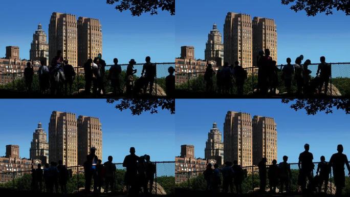 白天夏天在中央公园建立剪影游客的照片