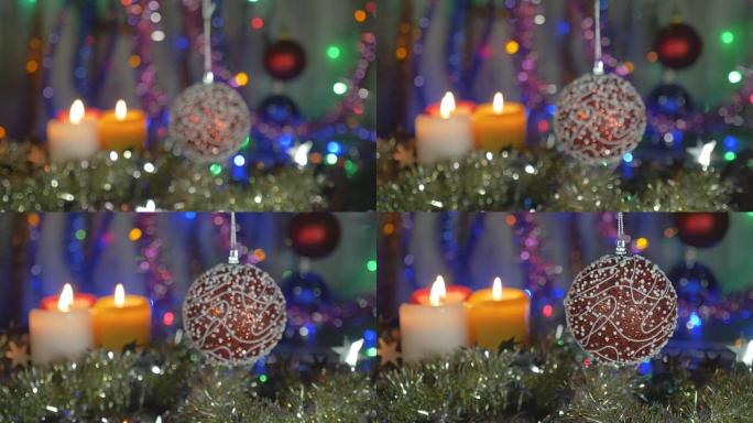 一个美丽的红球。新年和圣诞装饰品。闪光花环。背景模糊。将相机从非对焦区域移动到对焦对象。