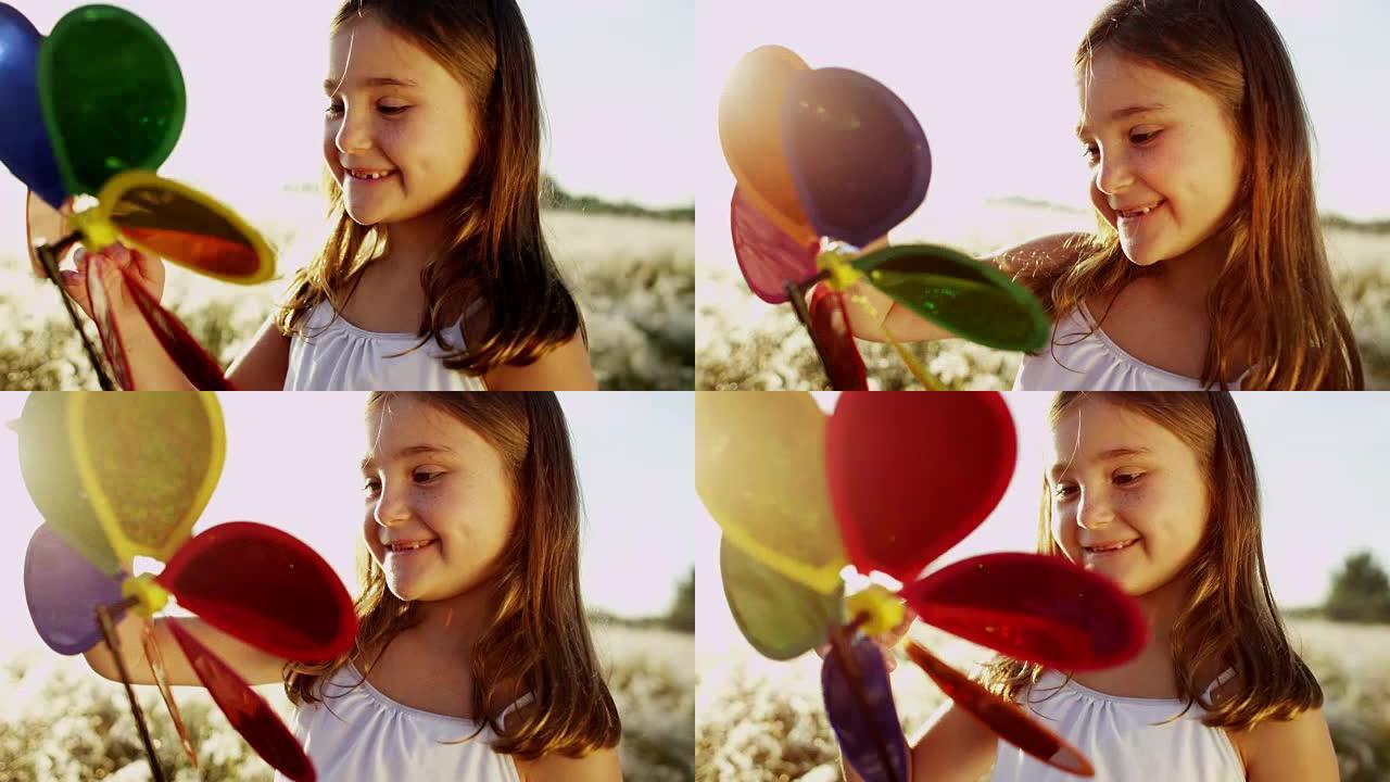小高加索女孩玩玩具彩虹风车