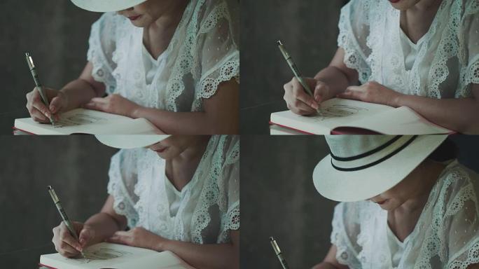 戴着白帽子，穿着复古白色连衣裙的亚洲艺术家正在为周末的休闲活动写作和素描