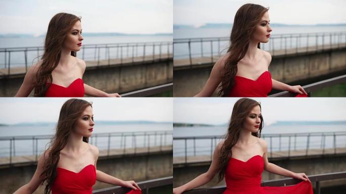 年轻可爱的女人穿着红色连衣裙，在夏日里在大自然中