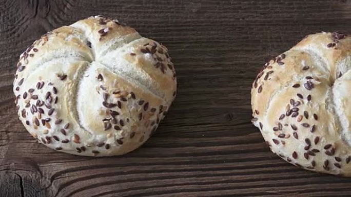 Tasty freshly baked kaiser rolls with seeds on woo