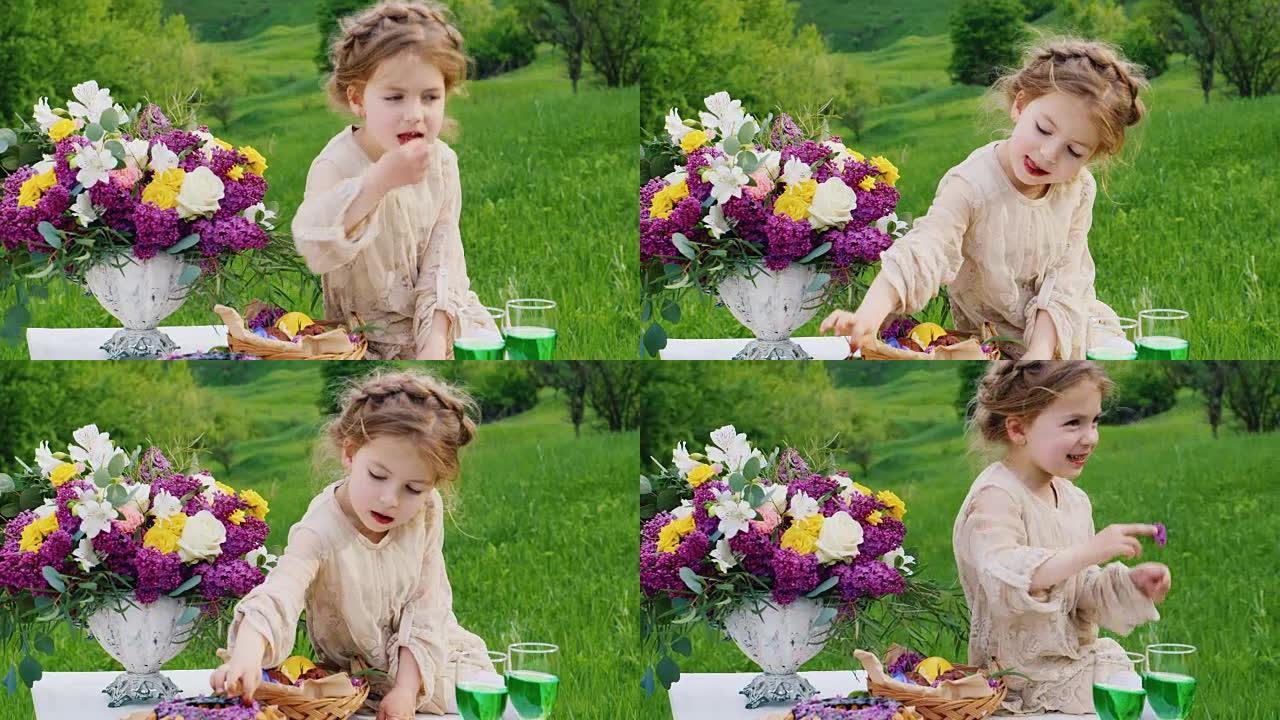 一个穿着漂亮衣服的小女孩坐在摆满鲜花的桌子上，吃巧克力。圣帕特里克节野餐
