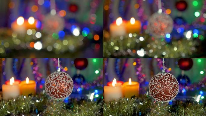 一个美丽的红球。新年和圣诞装饰品。闪光花环。背景模糊。