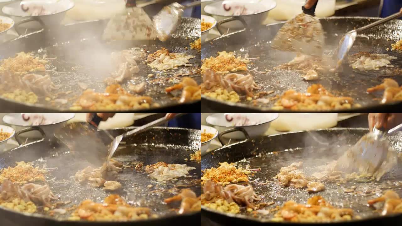 亚洲街头美食。海鲜，在大煎锅上煮鸡蛋的米粉。泰国