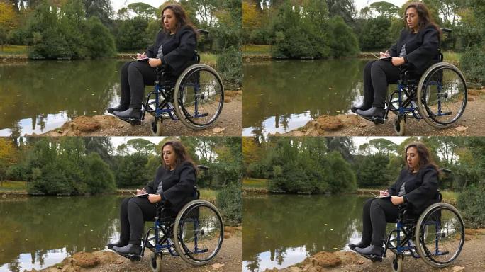 轮椅上的女人的肖像在湖边写了一封情书