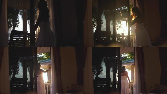 年轻漂亮的女孩打开门，窗帘穿过阳光进入露台，享受清晨日出时的瞬间，镜头闪光效果。慢动作。3840x2