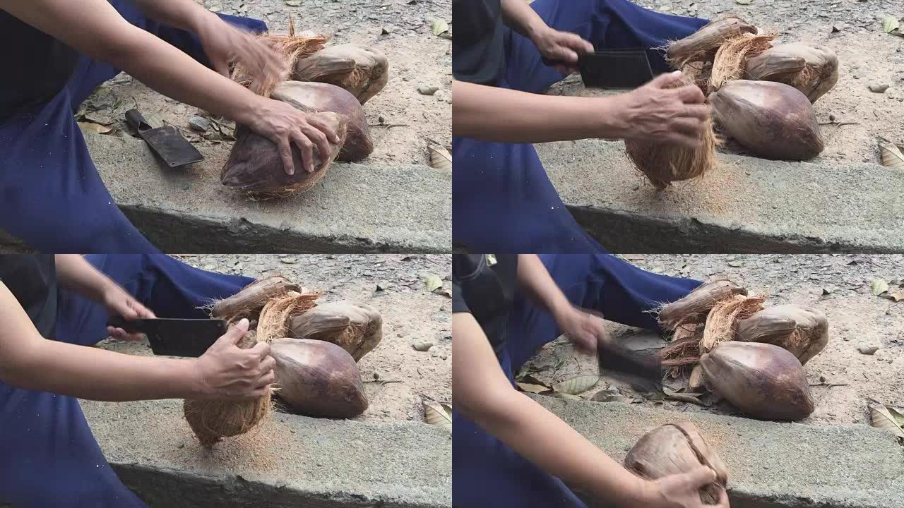 亚洲泰国女子用大刀打开老椰子