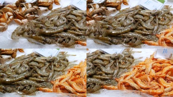 西班牙巴塞罗那的La Boqueria冰上市场上的海鲜关闭。海鲜螃蟹龙虾鱿鱼虾小龙虾牡蛎贻贝贝壳在西