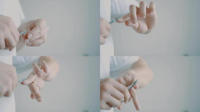 女人的手是用指甲剪修剪的指甲。在家修指甲。