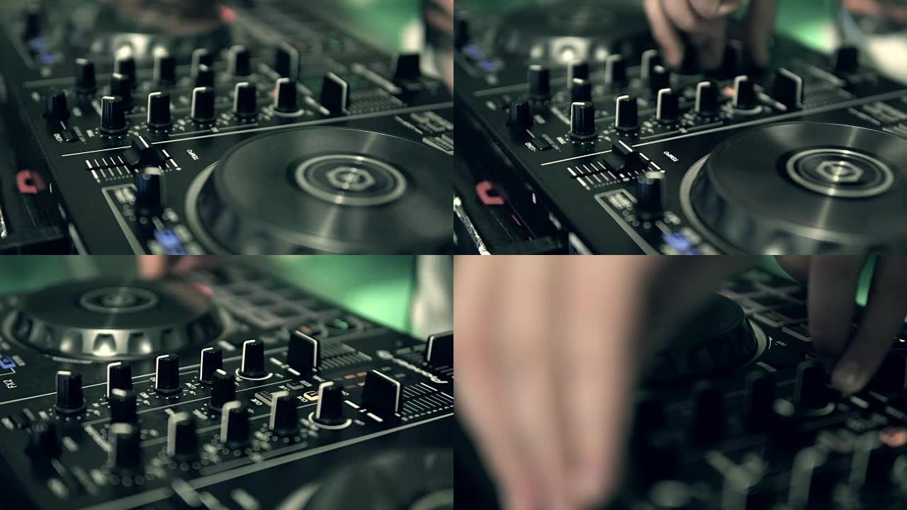 DJ调整DJ控制面板上的轨道控件。