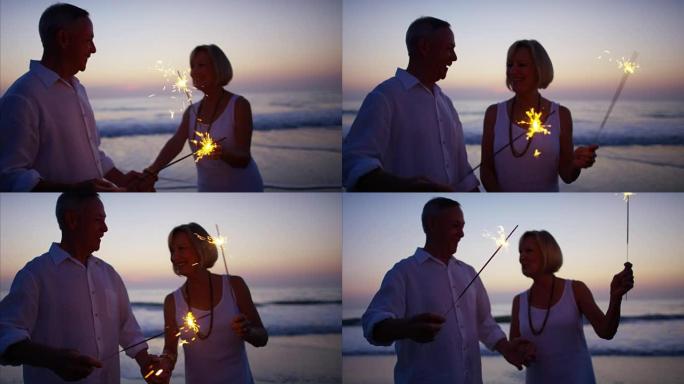 Retired Caucasian couple with sparklers on beach v