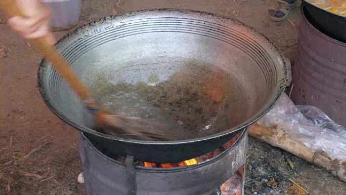 close up of a man washing a hot wok cooking with a