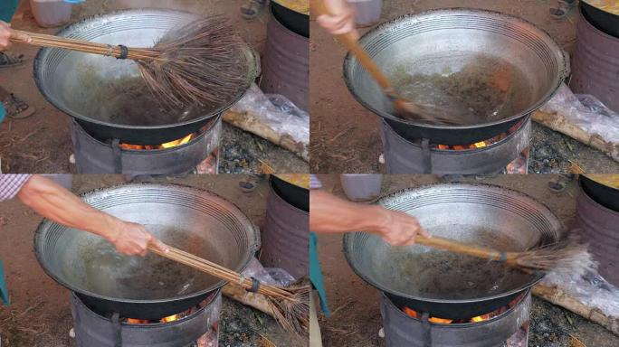 close up of a man washing a hot wok cooking with a