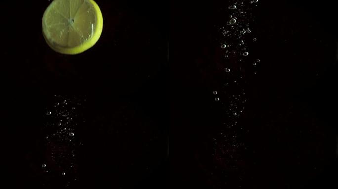 圆形新鲜多汁的柠檬片浸入透明的水中，并带有爆炸性的惊人飞溅，破坏了液体的表面。在黑色背景上拍摄的水下