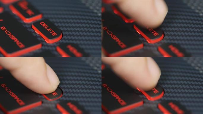 人体手指按下电脑键盘上的删除按钮的特写