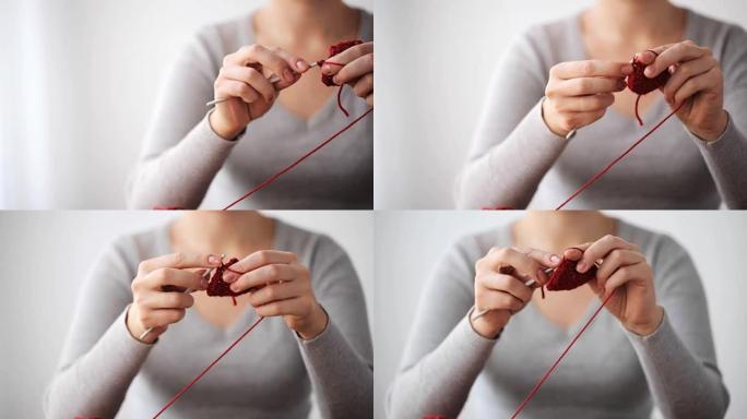 用钩针和红色纱线编织的女人