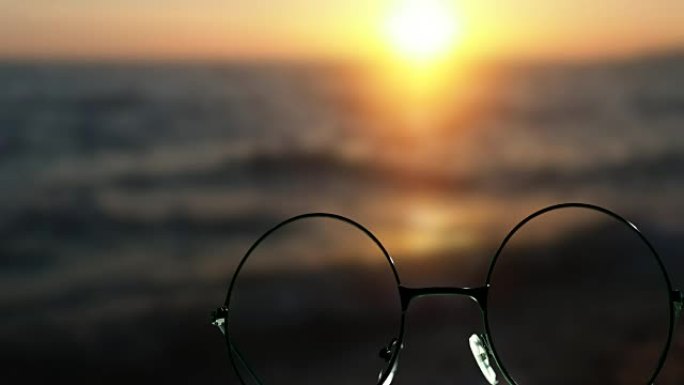 通过眼镜在海上日落