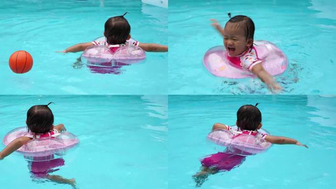 亚洲可爱八个月宝宝玩游泳池。