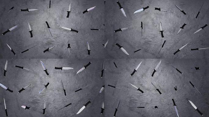 灰色背景上旋转的刀的动画。钢刀刀片。刀片刀的特写