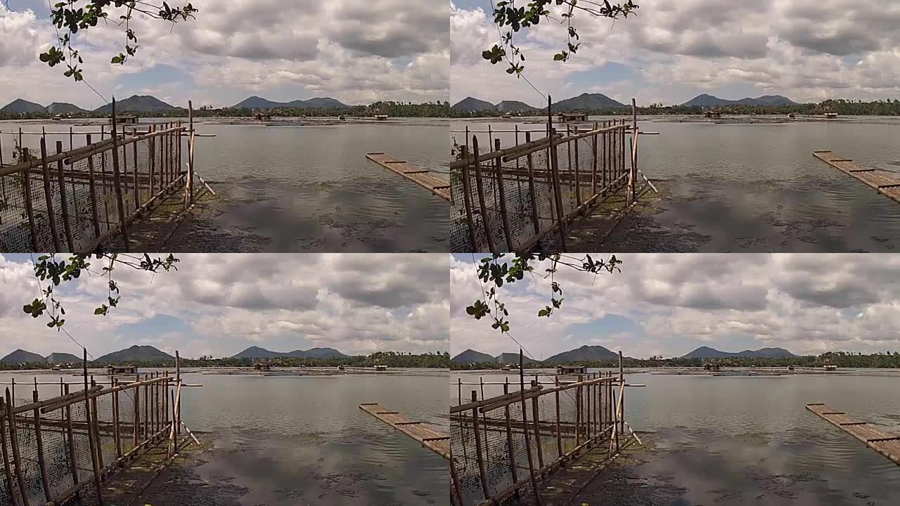 竹竿旁边的竹筏用来维护湖岸的鱼笼围栏。跟踪镜头