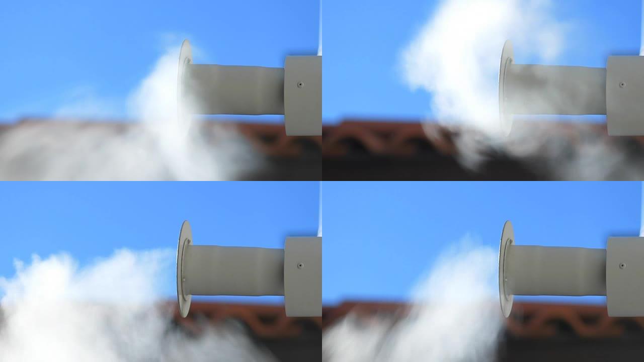 烟从屋顶背景的烟囱升起。