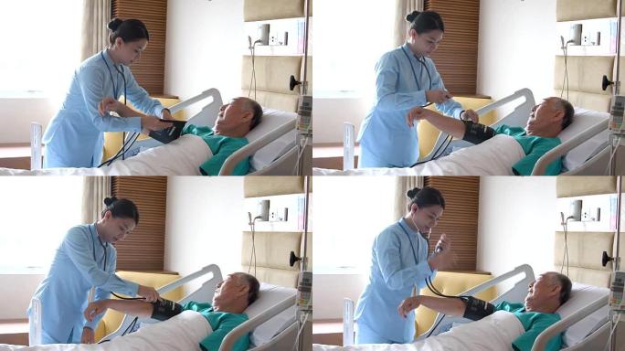 护士在医院的病床上测量老人的血压