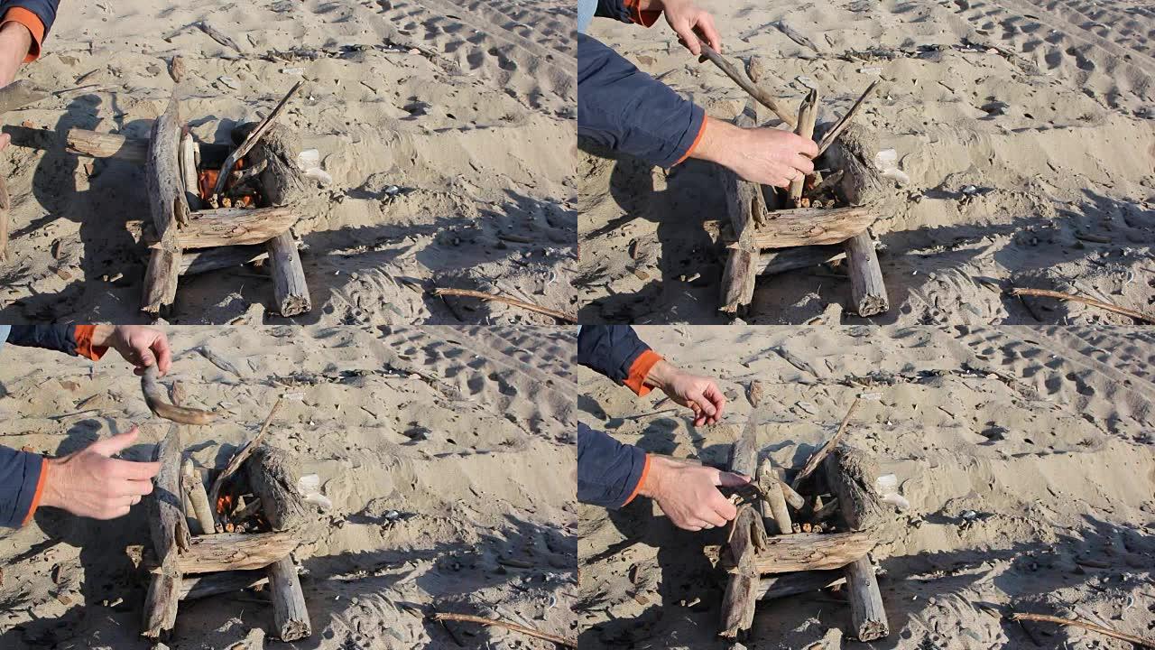男人的手以沙子上的井的形式点燃火