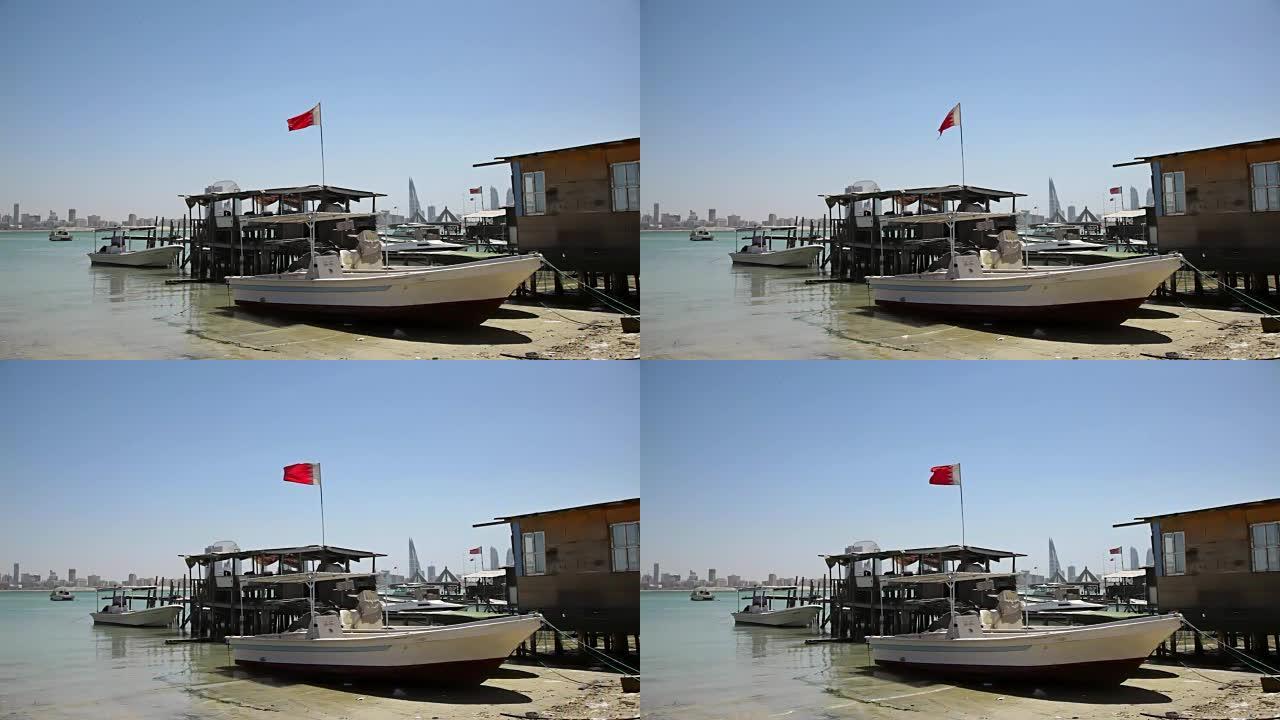 巴林。渔民的房子和船。旗帜和麦纳麦天际线