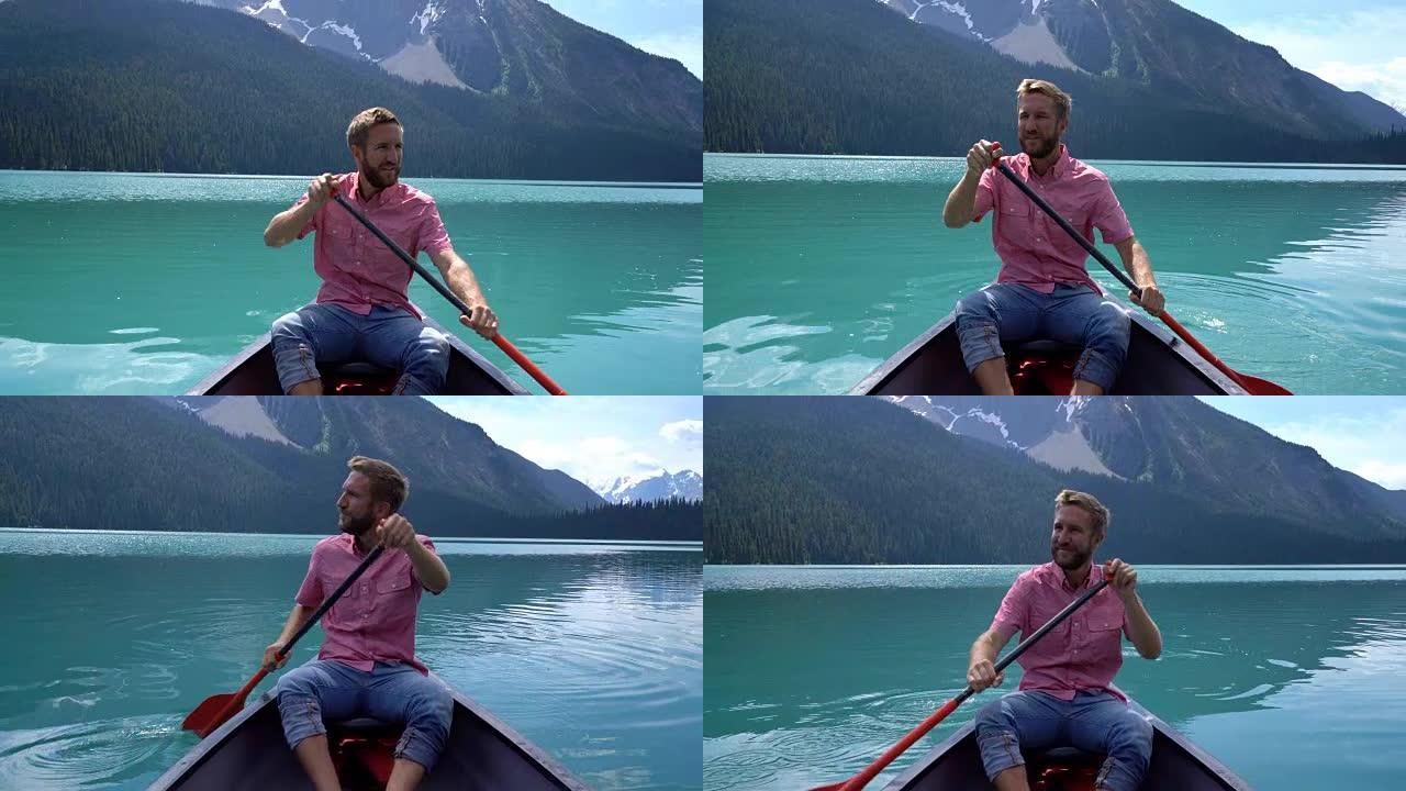 年轻人在令人惊叹的原始翡翠湖上划独木舟