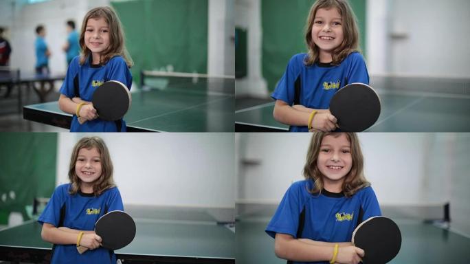 一个小女孩拿着乒乓球拍的肖像