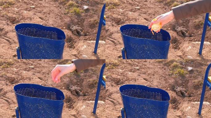 女人的手在城市公园的骨灰盒里扔普通话的清洁。