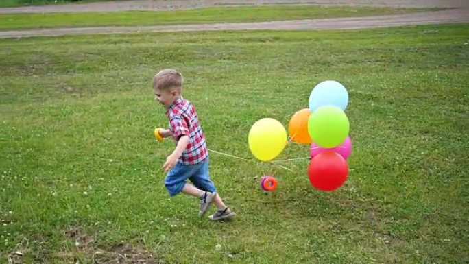 快乐的小宝贝，玩气球跑来跑去。户外娱乐。庆祝和乐趣。孩子的生日