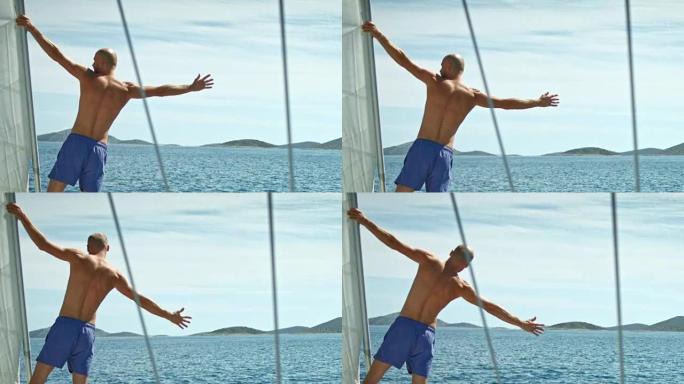 一只胳膊挂在桅杆上的人。看海