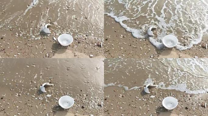 沙滩上的垃圾塑料杯