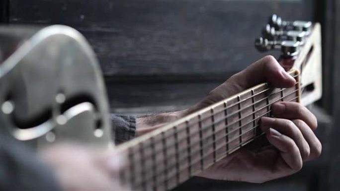 closeup of hand playing guitar