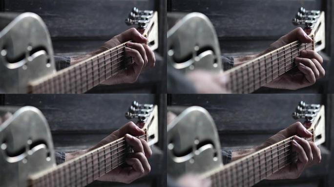closeup of hand playing guitar
