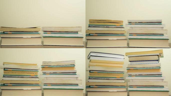 深色木制背景上堆放的书。阅读概念。时间流逝。加速逐帧拍摄